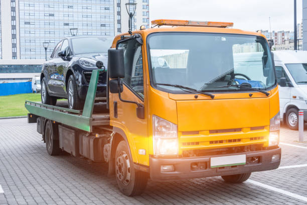 Passenger car loaded onto a recovery truck for transportation